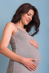 Image showing Portrait of pregnant woman over blue background