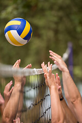 Image showing group of young friends playing Beach volleyball