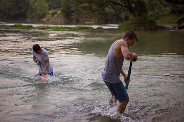 Image showing young men having fun with water guns