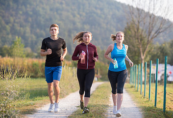 Image showing young people jogging on country road