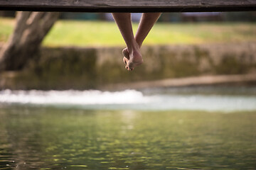 Image showing people sitting at wooden bridge