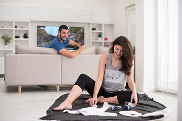 Image showing pregnant couple checking a list of things for their unborn baby