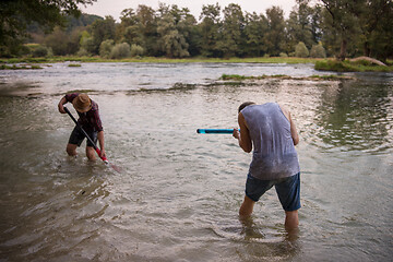 Image showing young men having fun with water guns