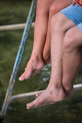 Image showing people sitting at wooden bridge