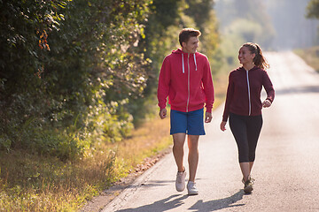 Image showing young couple jogging along a country road