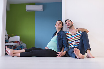 Image showing pregnant couple sitting on the floor