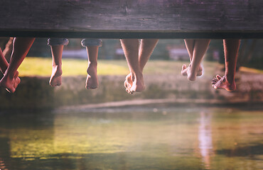 Image showing people sitting at wooden bridge