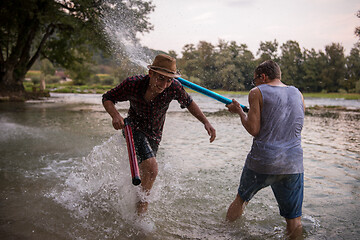 Image showing young men having fun with water guns