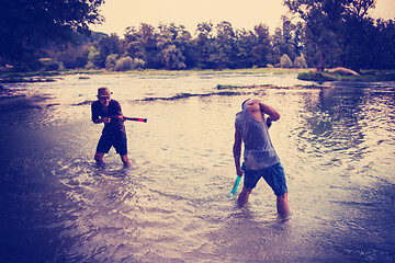 Image showing young men having fun with water guns