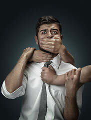 Image showing A young man surrounded by hands like his own thoughts