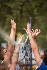 Image showing group of young friends playing Beach volleyball