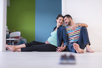 Image showing pregnant couple sitting on the floor