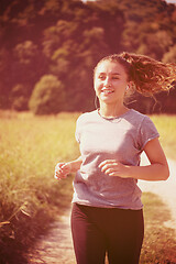 Image showing woman jogging along a country road