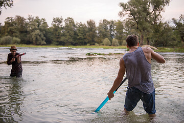 Image showing young men having fun with water guns