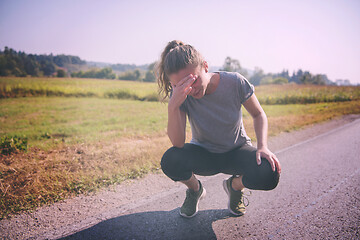 Image showing woman jogging along a country road