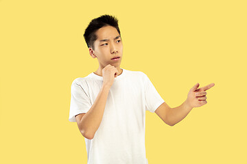 Image showing Korean young man\'s half-length portrait on yellow background