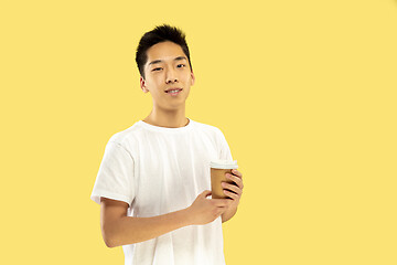 Image showing Korean young man\'s half-length portrait on yellow background