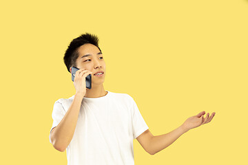 Image showing Korean young man\'s half-length portrait on yellow background