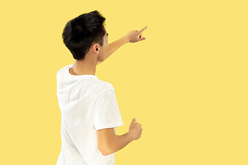 Image showing Korean young man\'s half-length portrait on yellow background