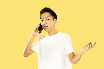 Image showing Korean young man\'s half-length portrait on yellow background