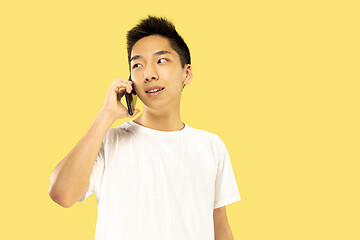 Image showing Korean young man\'s half-length portrait on yellow background