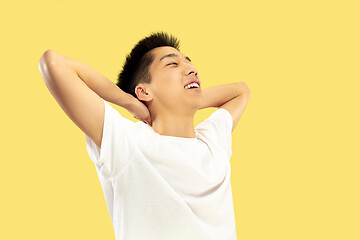 Image showing Korean young man\'s half-length portrait on yellow background