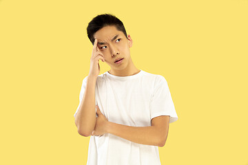 Image showing Korean young man\'s half-length portrait on yellow background