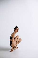 Image showing Young female ballet dancer against white studio background