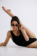 Image showing Young female ballet dancer against white studio background