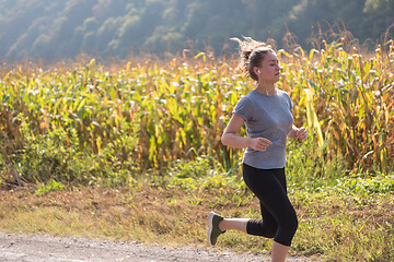 Image showing woman jogging along a country road