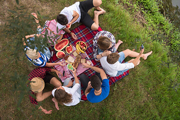 Image showing top view of group friends enjoying picnic time