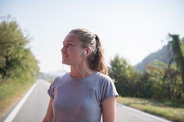 Image showing woman jogging along a country road