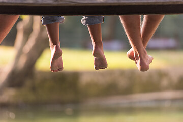 Image showing people sitting at wooden bridge