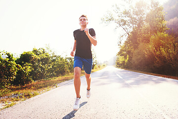 Image showing man jogging along a country road