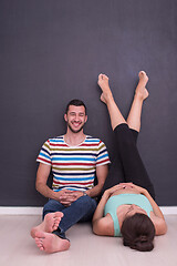 Image showing pregnant couple relaxing on the floor