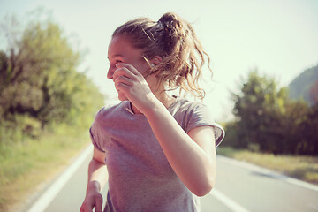 Image showing woman jogging along a country road