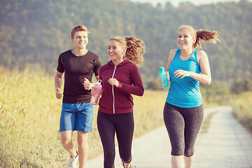 Image showing young people jogging on country road