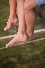 Image showing people sitting at wooden bridge