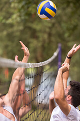 Image showing group of young friends playing Beach volleyball