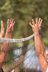 Image showing group of young friends playing Beach volleyball