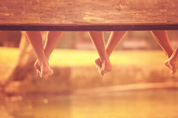 Image showing people sitting at wooden bridge