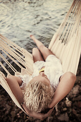 Image showing blonde woman resting on hammock