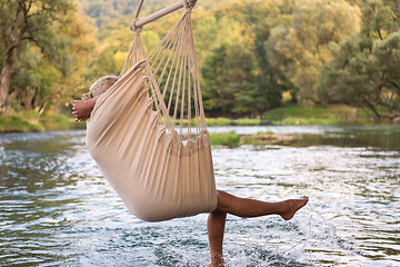 Image showing blonde woman resting on hammock