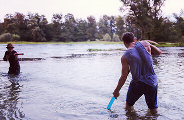 Image showing young men having fun with water guns