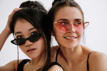 Image showing Two young female ballet dancers against white studio background