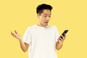 Image showing Korean young man\'s half-length portrait on yellow background