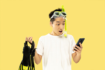 Image showing Korean young man\'s half-length portrait on yellow background