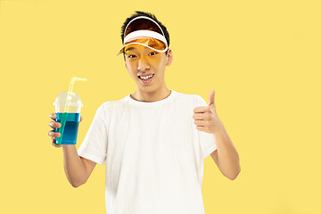 Image showing Korean young man\'s half-length portrait on yellow background