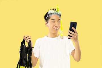 Image showing Korean young man\'s half-length portrait on yellow background