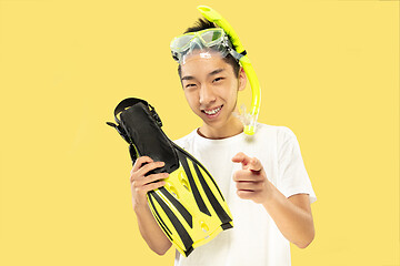 Image showing Korean young man\'s half-length portrait on yellow background